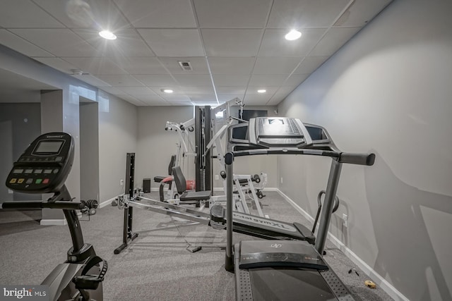 exercise room featuring a paneled ceiling, baseboards, visible vents, and recessed lighting