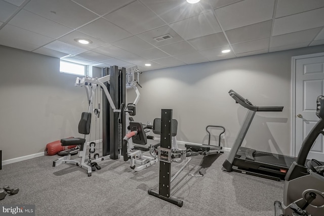 workout room featuring baseboards, visible vents, a drop ceiling, and recessed lighting