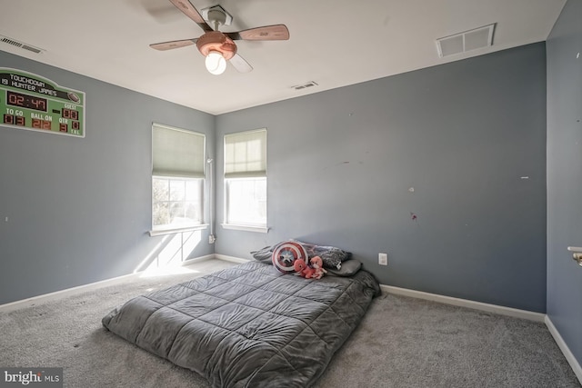 carpeted bedroom with baseboards, visible vents, and ceiling fan