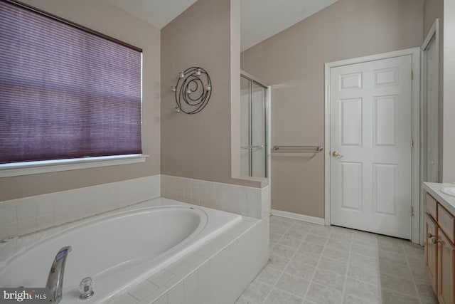 full bath with a garden tub and vanity