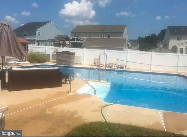 view of pool with a patio area, a fenced backyard, and a fenced in pool