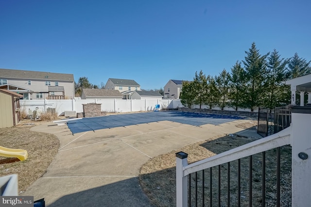 view of pool with a patio area, a fenced backyard, and a fenced in pool