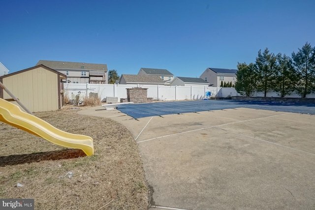 view of pool with a fenced in pool, a patio area, a playground, and a fenced backyard