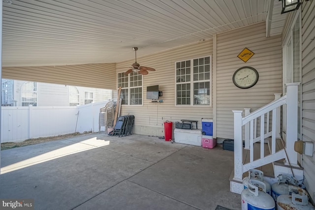 view of patio / terrace with ceiling fan and fence