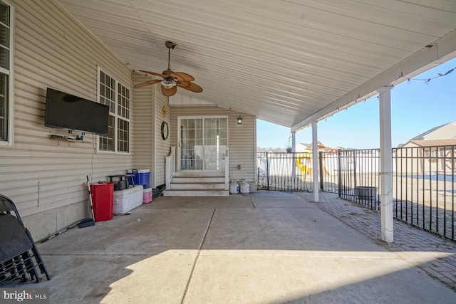 view of patio / terrace with entry steps, fence, and ceiling fan