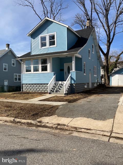 18 Waldron Ave, Pikesville, MD 21208 - bungalow-style house featuring a porch, a chimney, and aphalt driveway