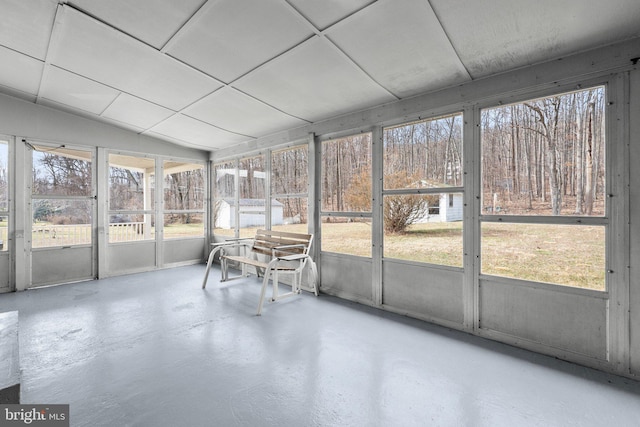 unfurnished sunroom featuring a healthy amount of sunlight and vaulted ceiling