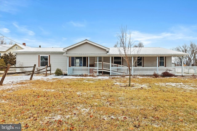 ranch-style home featuring a porch and a front yard