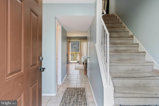 stairs with tile patterned floors