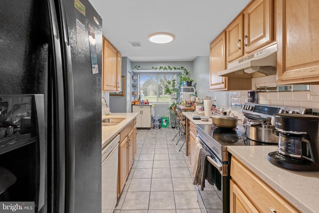 kitchen featuring stainless steel range with electric cooktop, black refrigerator with ice dispenser, light tile patterned floors, white dishwasher, and backsplash