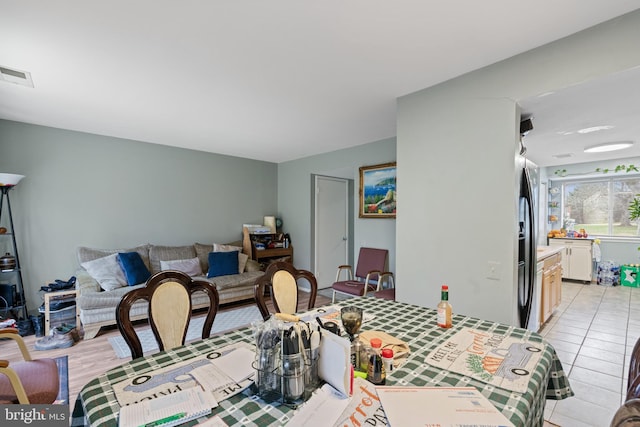 dining area featuring light tile patterned floors