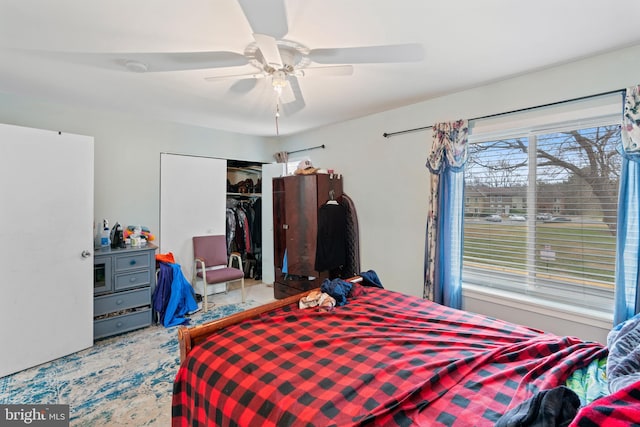 bedroom featuring ceiling fan and a closet