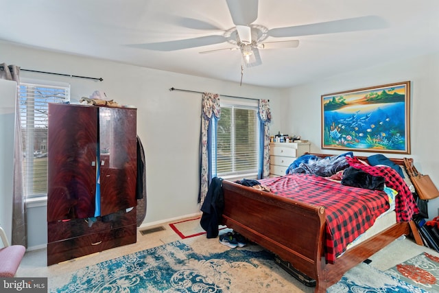 bedroom with light carpet and ceiling fan