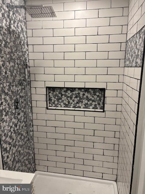 bathroom with a tile shower