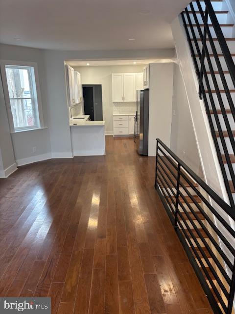 unfurnished living room with dark hardwood / wood-style floors