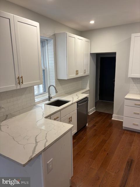 kitchen featuring white cabinetry, stainless steel dishwasher, and sink