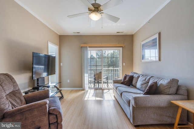 living room featuring ornamental molding, ceiling fan, and light hardwood / wood-style flooring