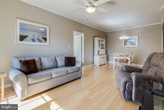 living room with light hardwood / wood-style flooring, ornamental molding, and ceiling fan