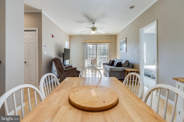 dining room featuring crown molding, hardwood / wood-style floors, and ceiling fan