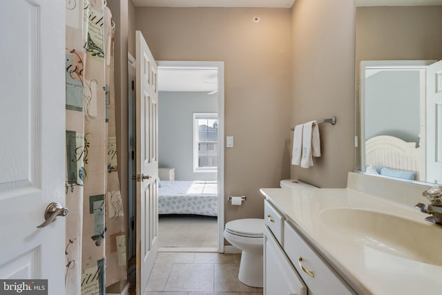 bathroom with tile patterned flooring, vanity, and toilet