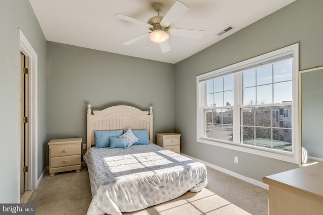 bedroom with light colored carpet and ceiling fan