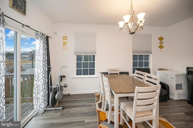 dining area featuring dark hardwood / wood-style floors and a chandelier