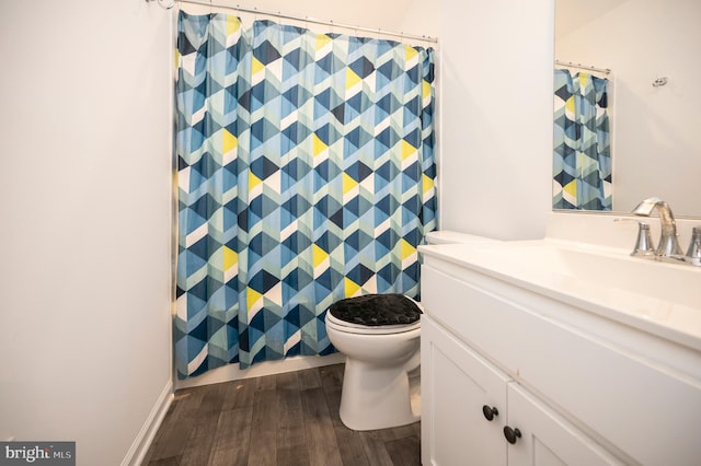 bathroom featuring vanity, toilet, and hardwood / wood-style floors