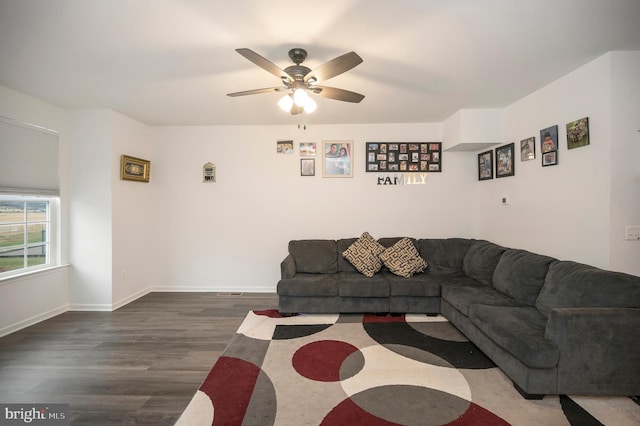 living room featuring ceiling fan and dark hardwood / wood-style flooring