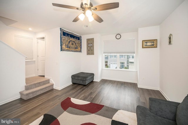 living room with dark hardwood / wood-style floors and ceiling fan