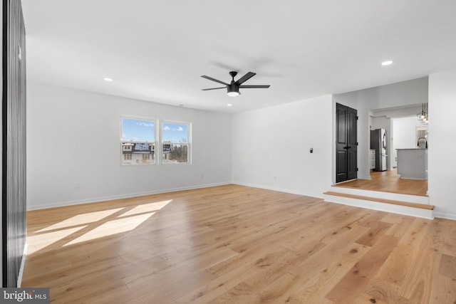 unfurnished room featuring light hardwood / wood-style flooring and ceiling fan