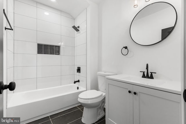 full bathroom with vanity, tiled shower / bath combo, tile patterned floors, and toilet