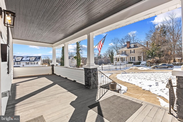 snow covered deck with covered porch