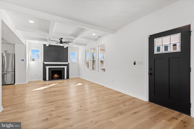 entryway with coffered ceiling, beam ceiling, light hardwood / wood-style floors, and ceiling fan