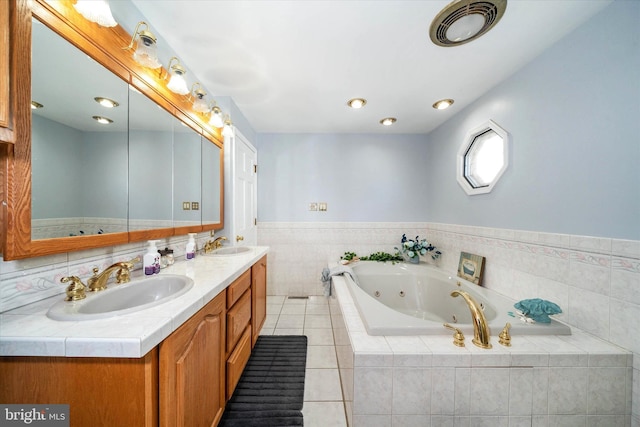 bathroom with a jetted tub, double vanity, visible vents, and a sink