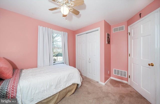 bedroom featuring a closet, carpet, visible vents, and a ceiling fan