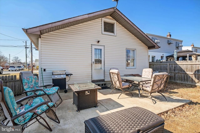 rear view of property with a patio, outdoor dining area, and fence