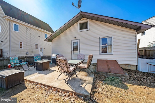 back of house with a patio and fence