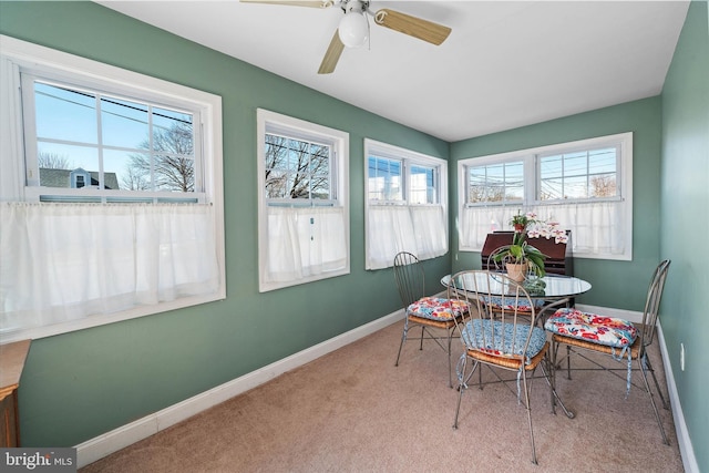 sunroom / solarium featuring a ceiling fan