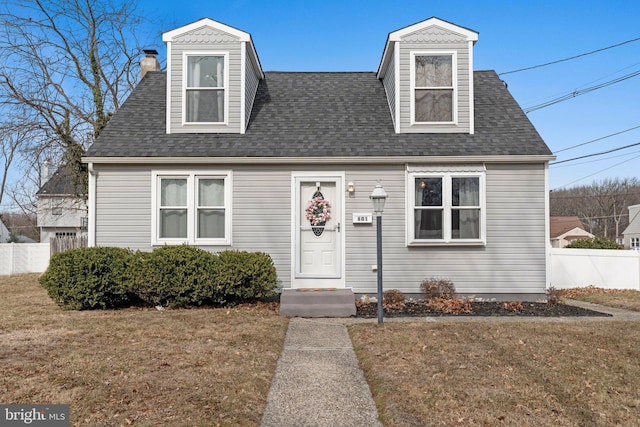 cape cod-style house featuring a front lawn