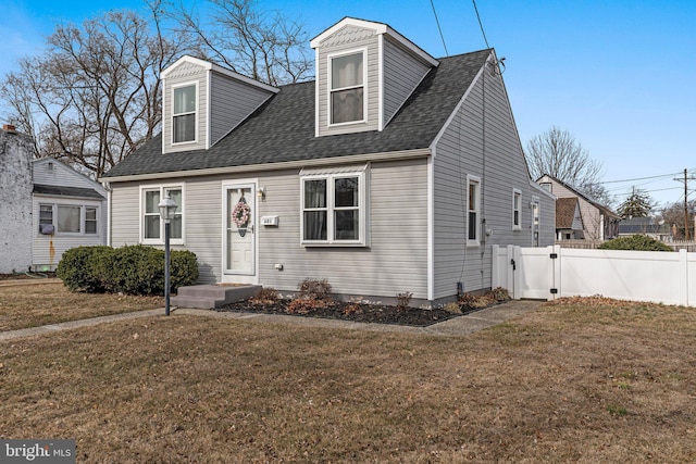 cape cod home with a front lawn