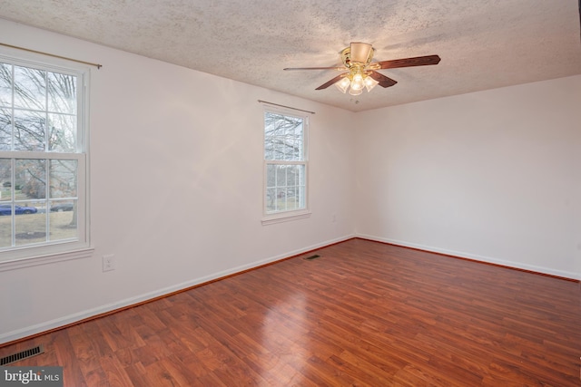 empty room featuring hardwood / wood-style flooring, ceiling fan, and a textured ceiling