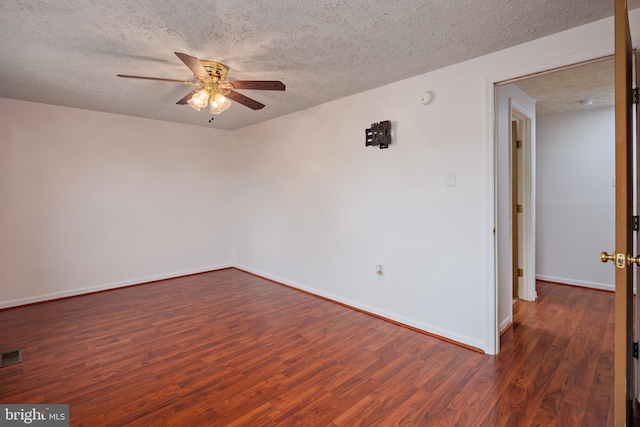 unfurnished room with dark wood-type flooring, a textured ceiling, and ceiling fan