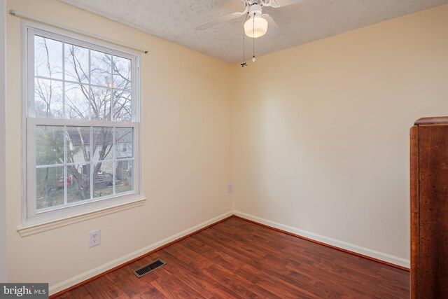 spare room with ceiling fan, wood-type flooring, and a textured ceiling