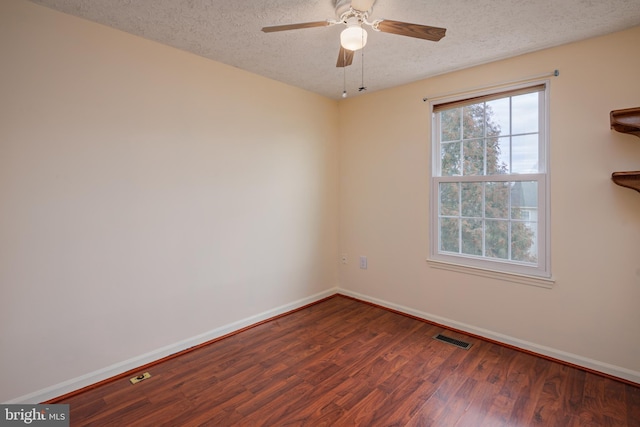 spare room featuring ceiling fan, a textured ceiling, and dark hardwood / wood-style flooring