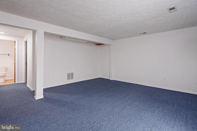 basement with a textured ceiling and carpet