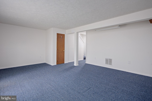 basement with carpet floors and a textured ceiling