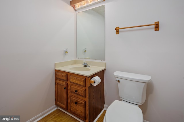 bathroom featuring hardwood / wood-style flooring, vanity, and toilet