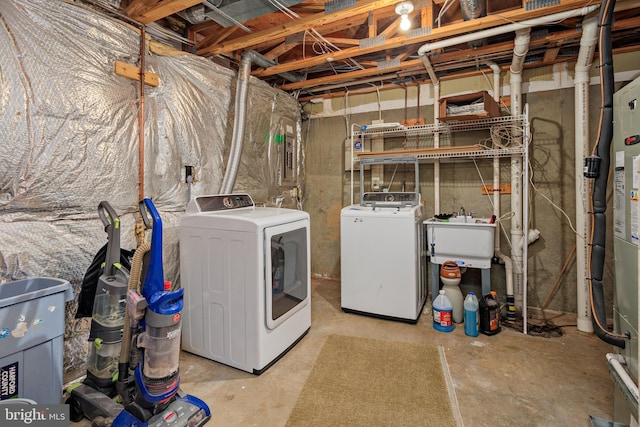 laundry room featuring sink and washer and dryer