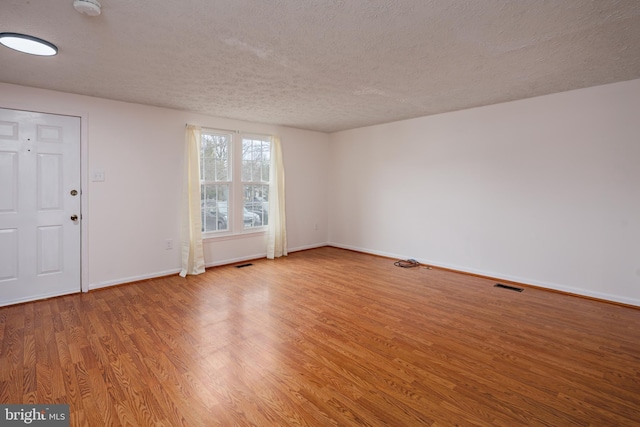 interior space featuring hardwood / wood-style floors and a textured ceiling