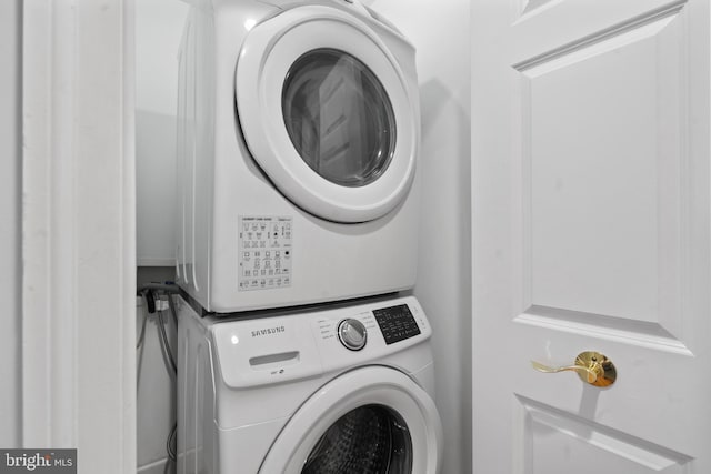 laundry room with stacked washer / drying machine